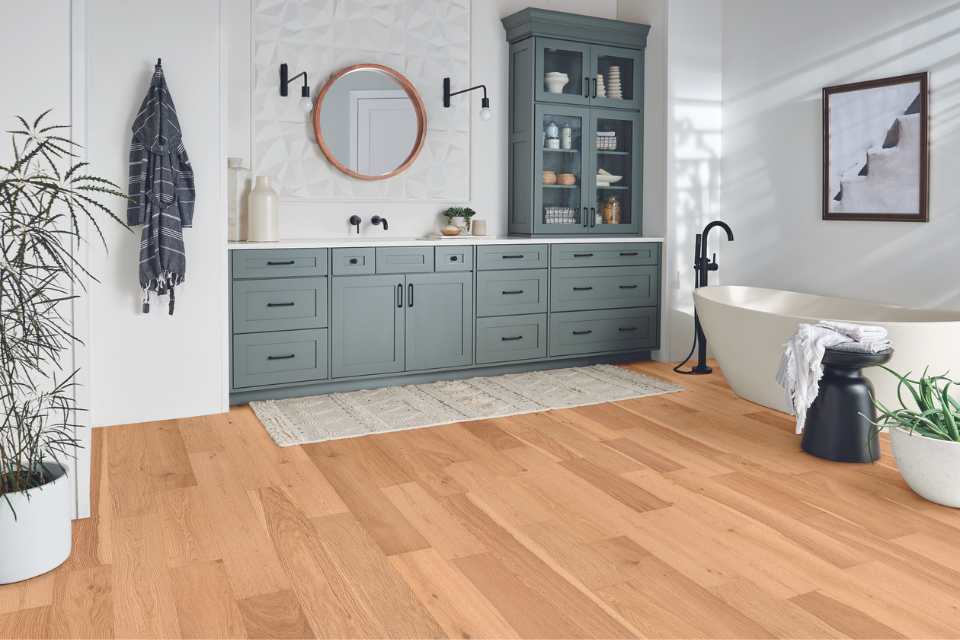 natural white oak engineered hardwood in modern bathroom with blue cabinetry